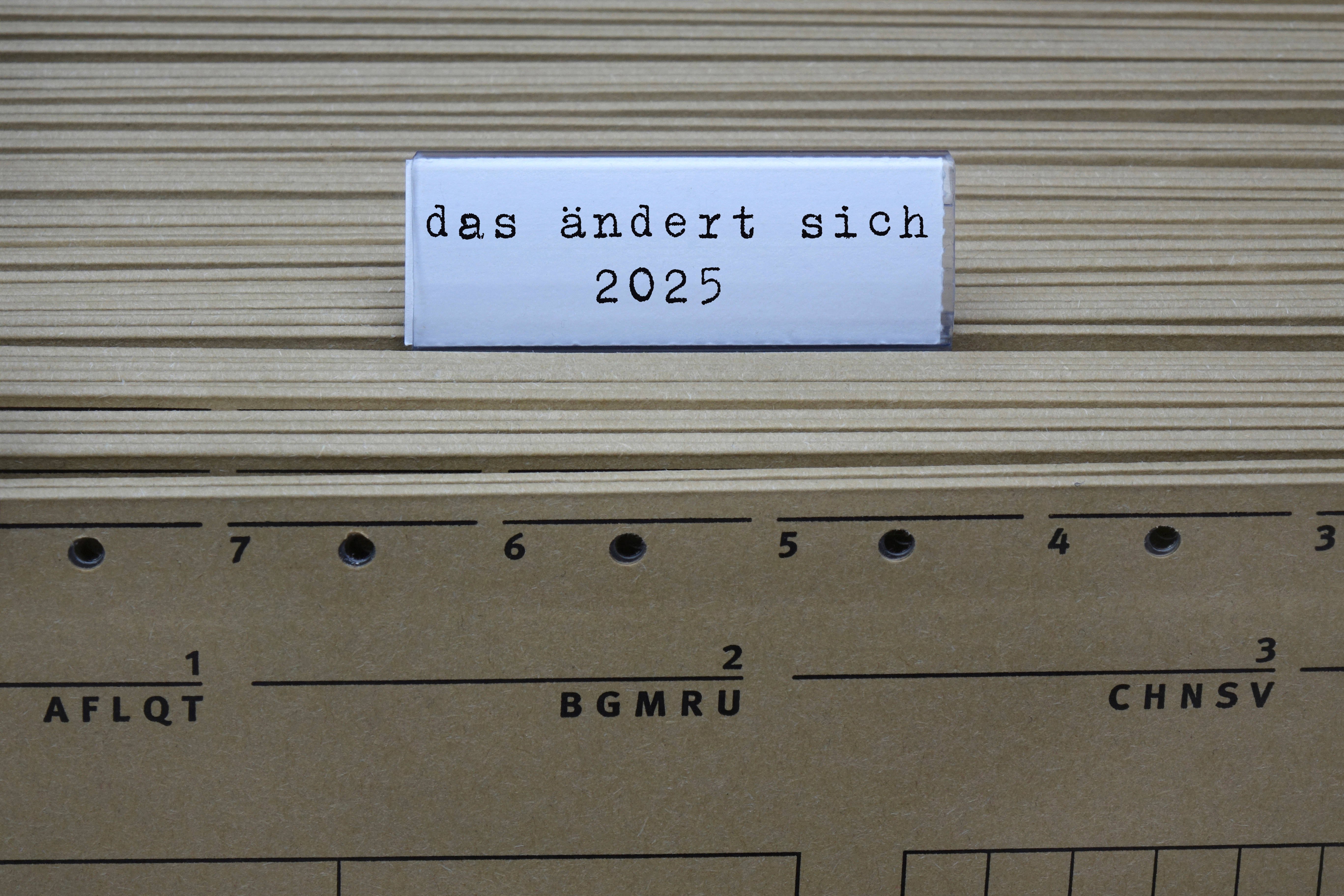 Was ändert sich 2025? Ein Hängeregister mit Akten, darüber ein Etikett "Das ändert sich 2025"