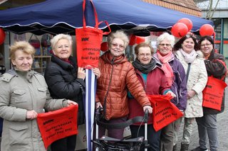 Frauen mit roten Luftballons und Taschen