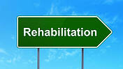 Ein Wegweiser-Schild, auf dem "Rehabilitation" steht