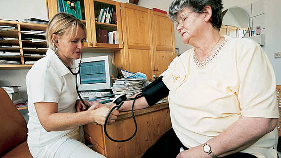 Symbolfoto: Eine Ärztin misst bei einer älteren Dame den Blutdruck.